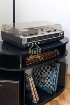 Detail shot of a record player and vinyl records on a shelf. - image 15