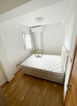Small bedroom with a double bed, wooden floor, and air conditioning unit. - image 5
