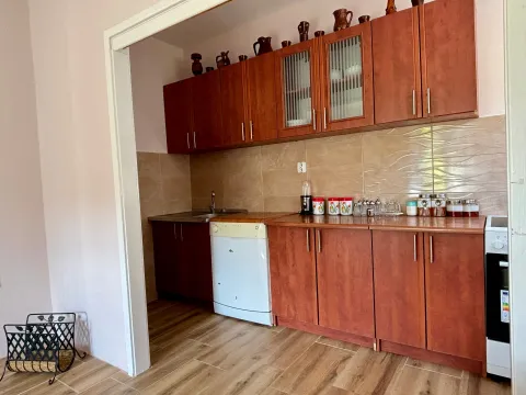 Small kitchen with wooden cabinetry and ceramic tiles. - image 5