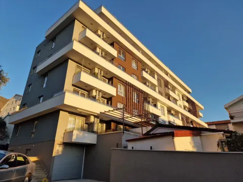 Exterior view of a modern residential building with balconies and a garage. - image 16