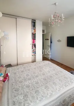 Furnished bedroom with a large double bed, wardrobe, and a chandelier. - image 10