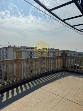 Spacious terrace with a view of surrounding buildings. - image 5