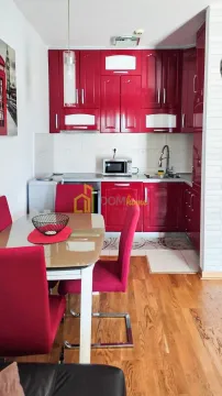 Kitchen with dining area and red cabinets. - image 2