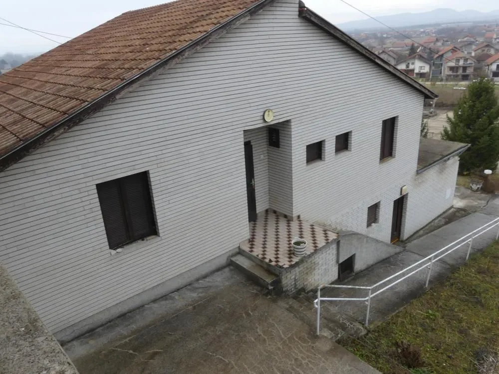 View of the exterior of the house with yard and entrance.