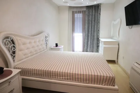 Bright bedroom featuring a large double bed and white furniture. - image 6