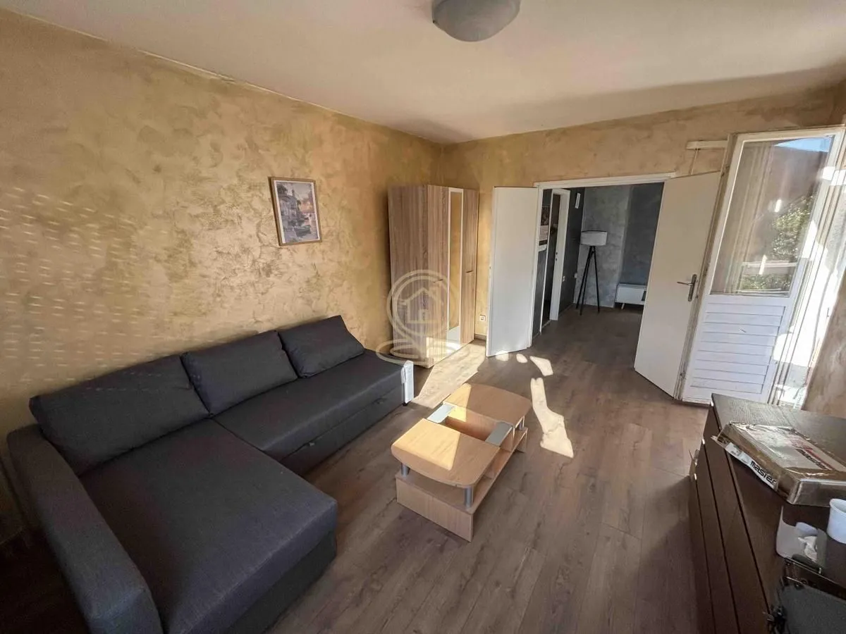 Living room with a sectional sofa, coffee table, and wardrobe.