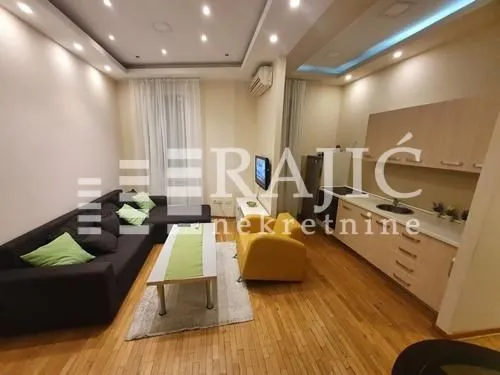 Living room with kitchen and dining area in a modern apartment.