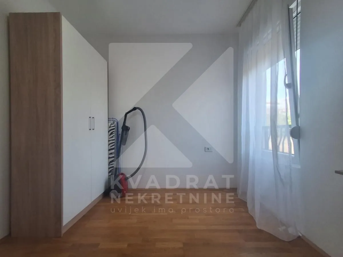 Smaller bedroom with a built-in wardrobe and a window.