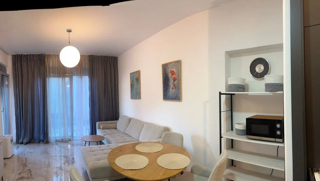 Living room with a sofa and a dining table.