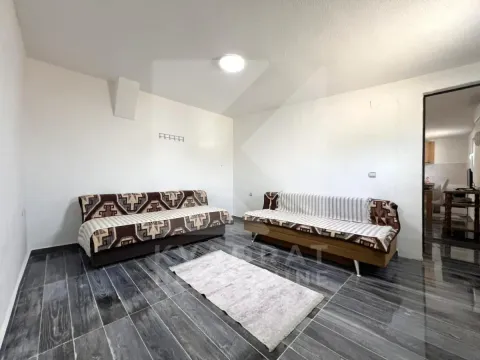 Living room with two sofas and dark flooring. - image 5