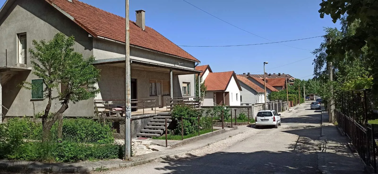 View of the exterior of the house with a yard in a quiet street.