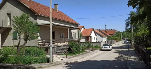 View of the exterior of the house with a yard in a quiet street. - image 2