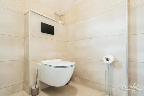 Moderno opremljeno kupatilo sa konzolnom wc šoljom i bež pločicama. - image 23