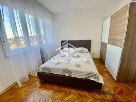 Furnished bedroom with a double bed, wardrobe, and parquet flooring. - image 4