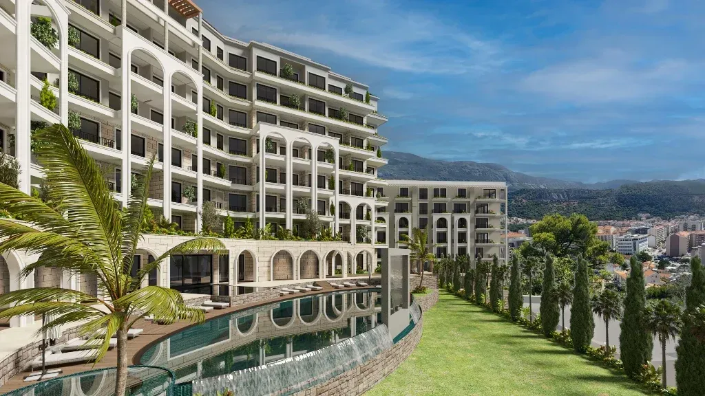 Exterior view of the residential complex with a swimming pool and landscaped courtyard.