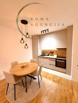 Modern kitchen with a dining table and chairs. - image 3