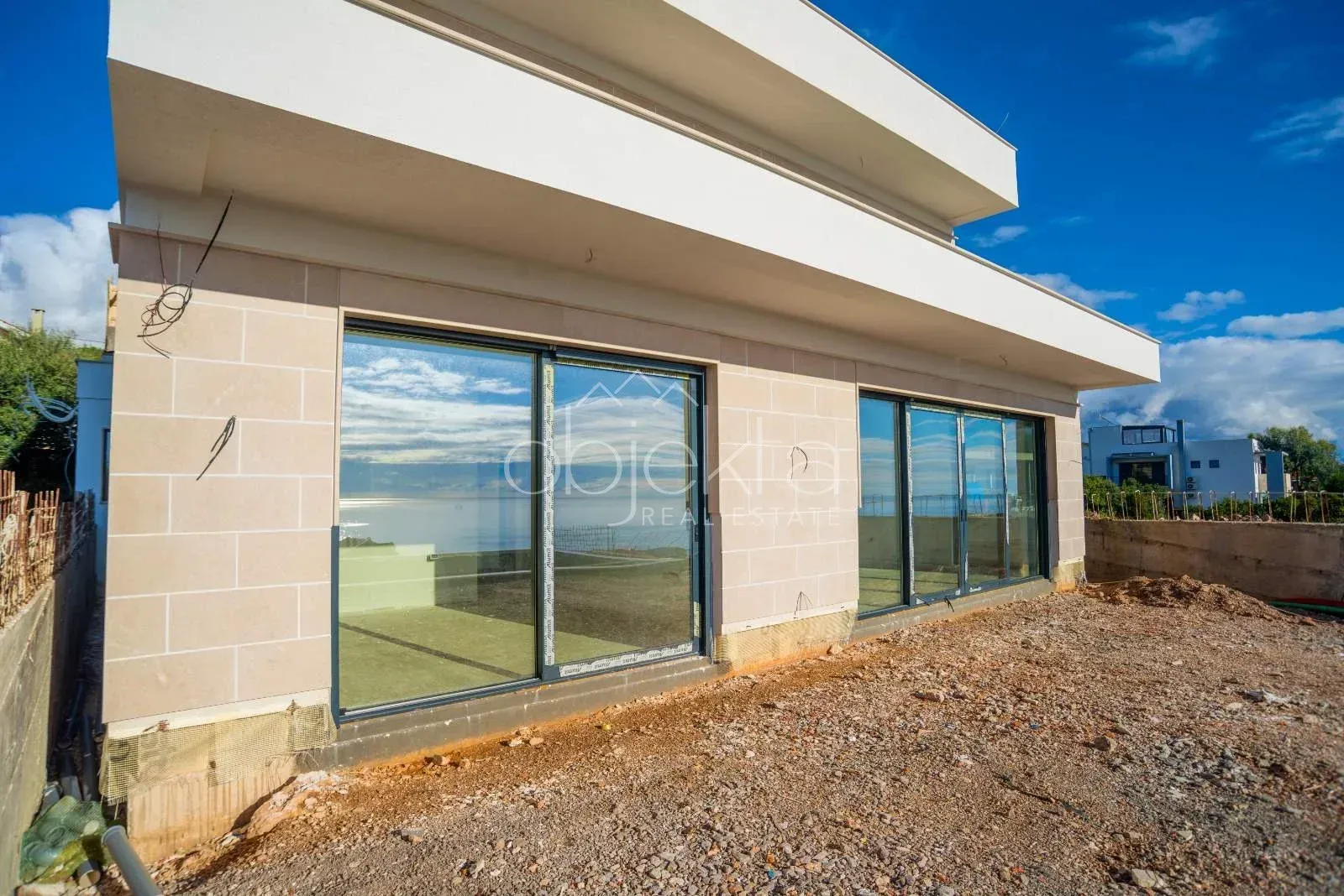 Exterior view of a modern building with large glass openings.