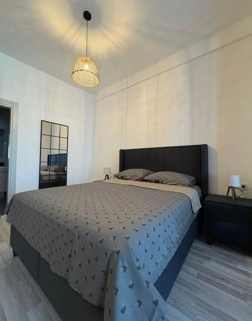 Furnished bedroom with a double bed and nightstands.