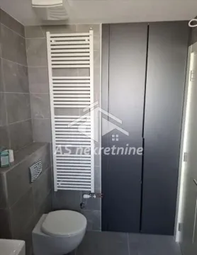 Bathroom with a toilet, white radiator and built-in closet. - image 24