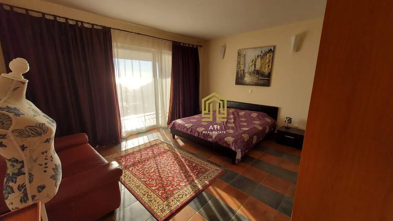 Furnished bedroom with a double bed, armchair, and access to the terrace.