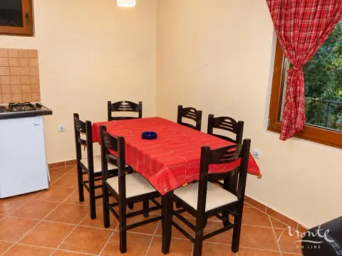 Dining table with chairs in the kitchen area. - image 4