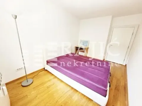 Bright bedroom with a double bed and wooden flooring. - image 9
