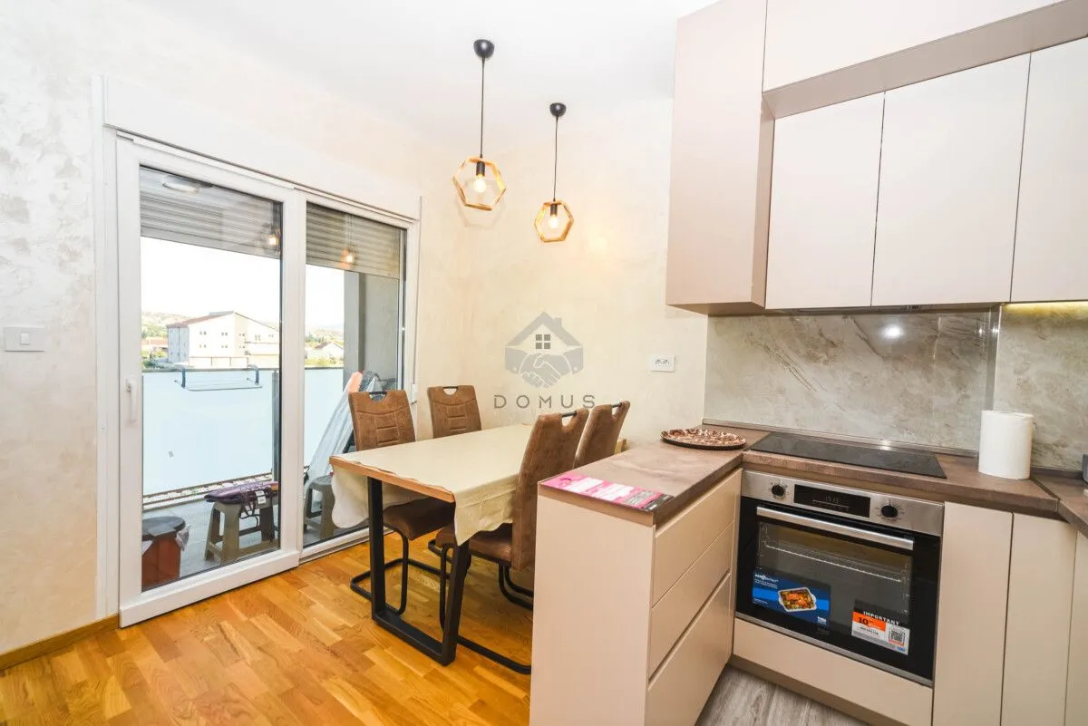Modern kitchen with dining area and access to the terrace.