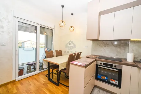 Modern kitchen with dining area and access to the terrace. - image 5