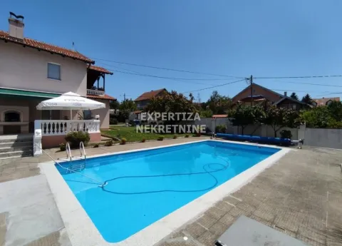 House yard with a swimming pool and sun terrace. - image 2