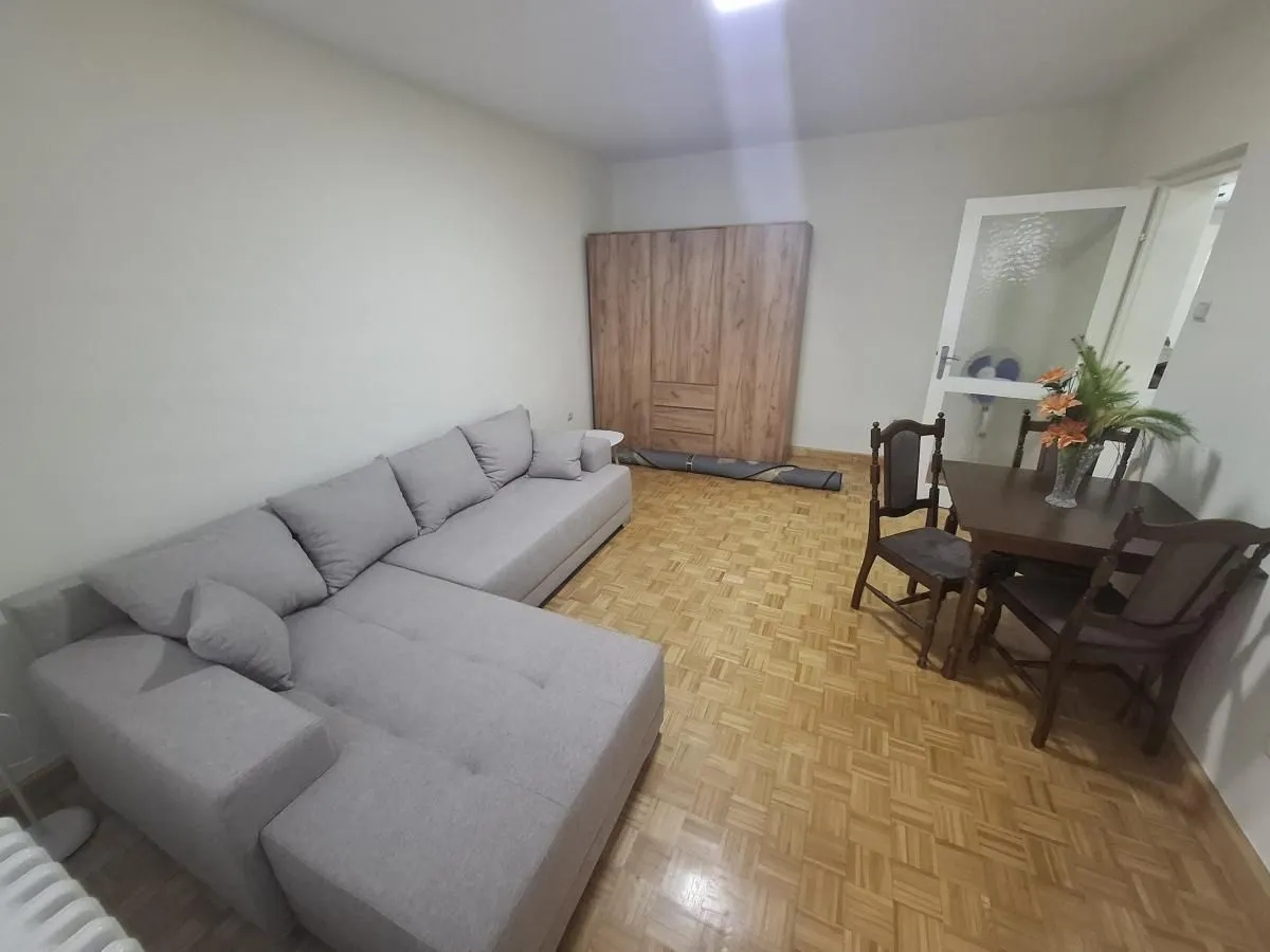 Living room with a sofa set and a dining table.