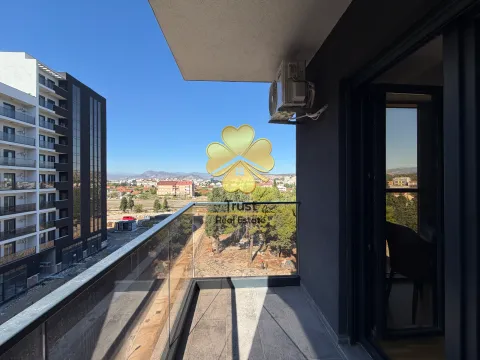 Modern balcony with a glass railing and city view. - image 11
