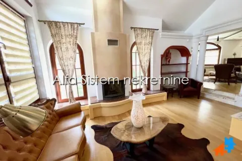 Spacious living room with a fireplace and wooden furniture. - image 3