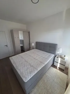 Furnished bedroom with a double bed, wardrobe, and nightstand. - image 5
