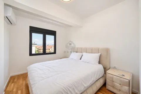 Bright bedroom with a double bed and a window overlooking the city. - image 9