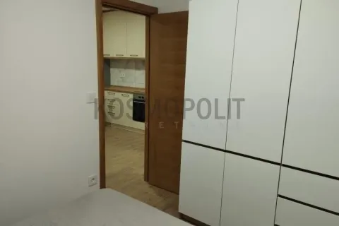 Bedroom with a built-in wardrobe and a view through the door into the kitchen. - image 5
