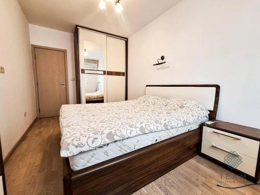 Furnished bedroom with a double bed, wardrobe, and a nightstand.