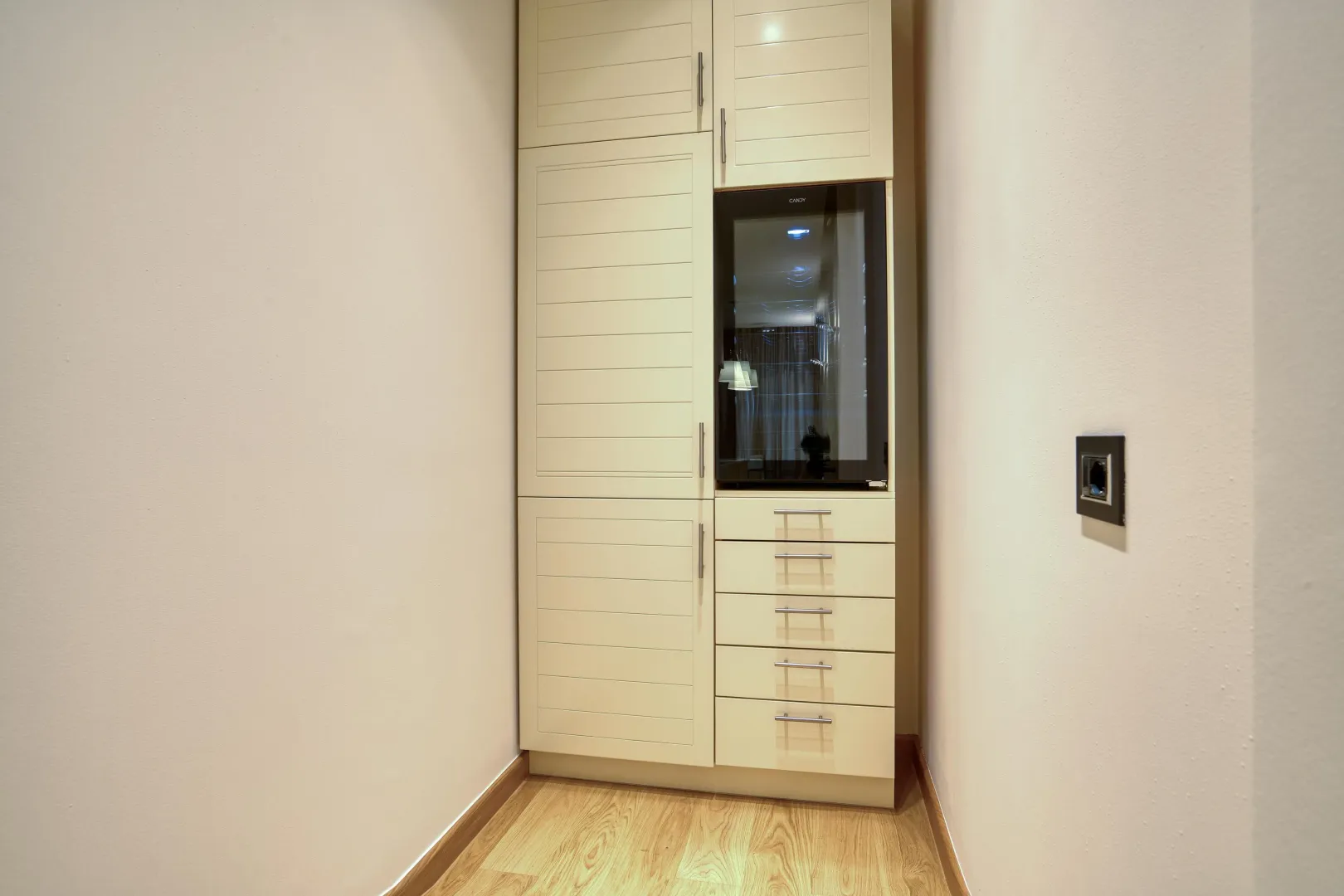 Built-in kitchen cabinets with a built-in refrigerator in a niche.