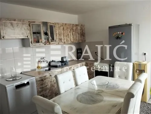 Kitchen with dining area and wooden cabinetry.