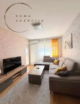 Furnished living room with a sofa and television. - image 2
