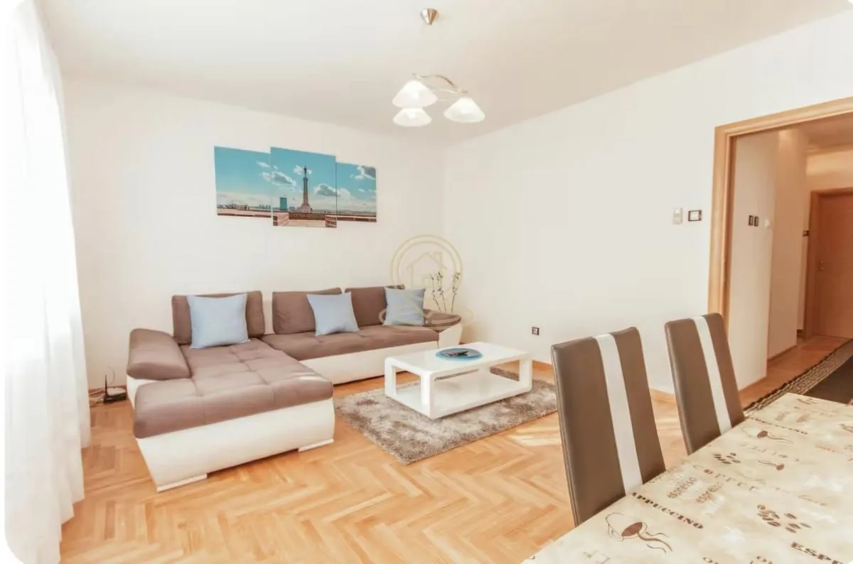 Living room with a corner sofa, coffee table, and dining table.