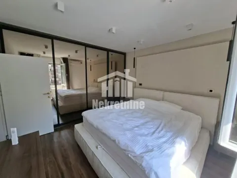 Furnished bedroom with a large bed and built-in wardrobes. - image 5