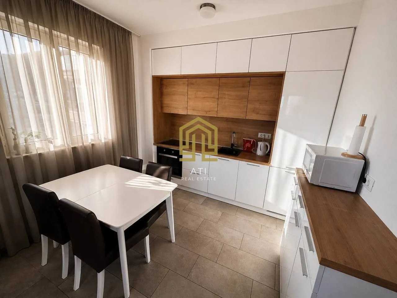 Modern kitchen with a dining table and window.