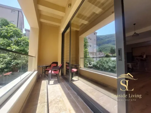 Spacious balcony with seating furniture and surrounding view. - image 17