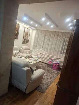 Living room with a sofa set, coffee table, and rug. - image 2