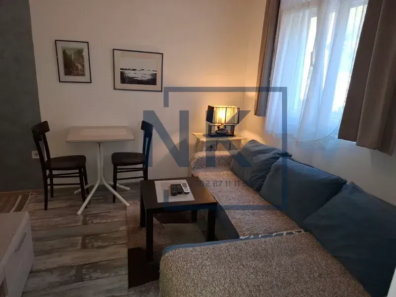 Living room with a sofa set, coffee table, and a dining table with chairs.