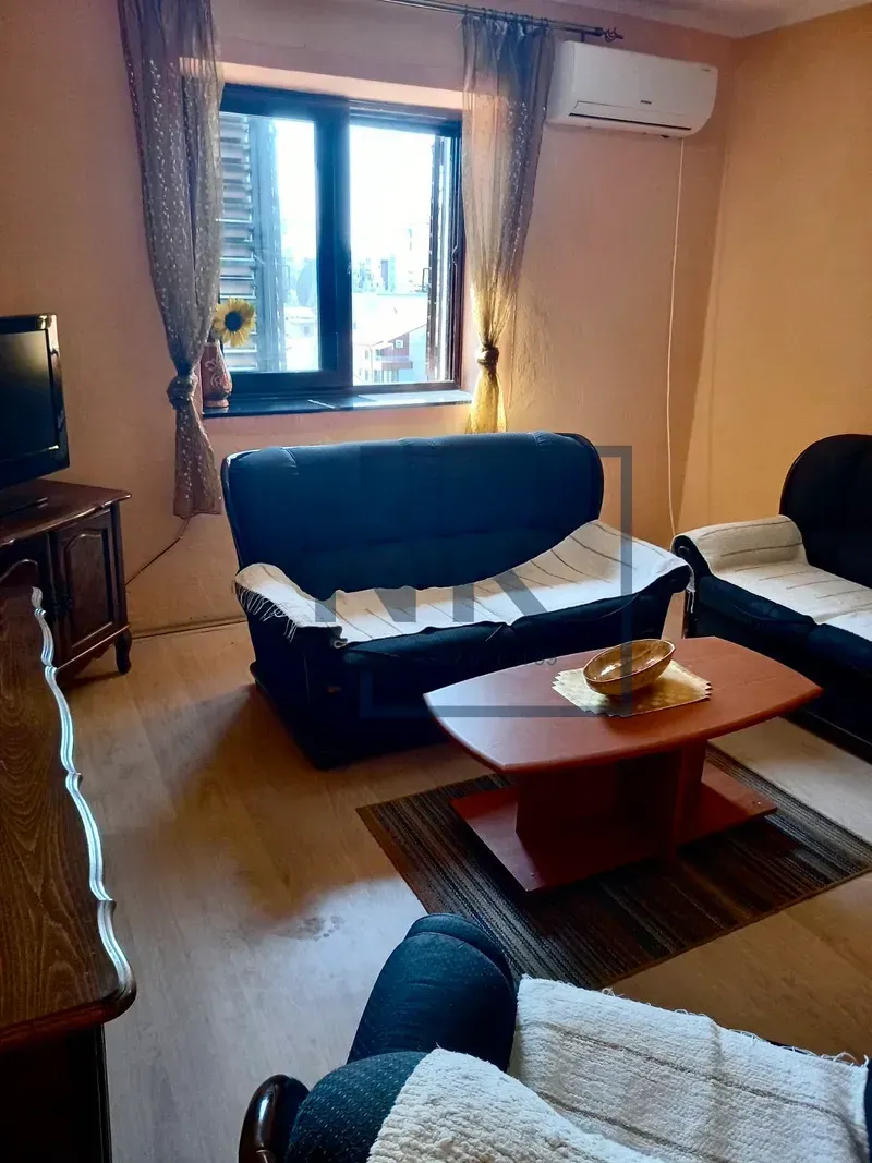 Living room with sofa seating, a coffee table, and a TV.