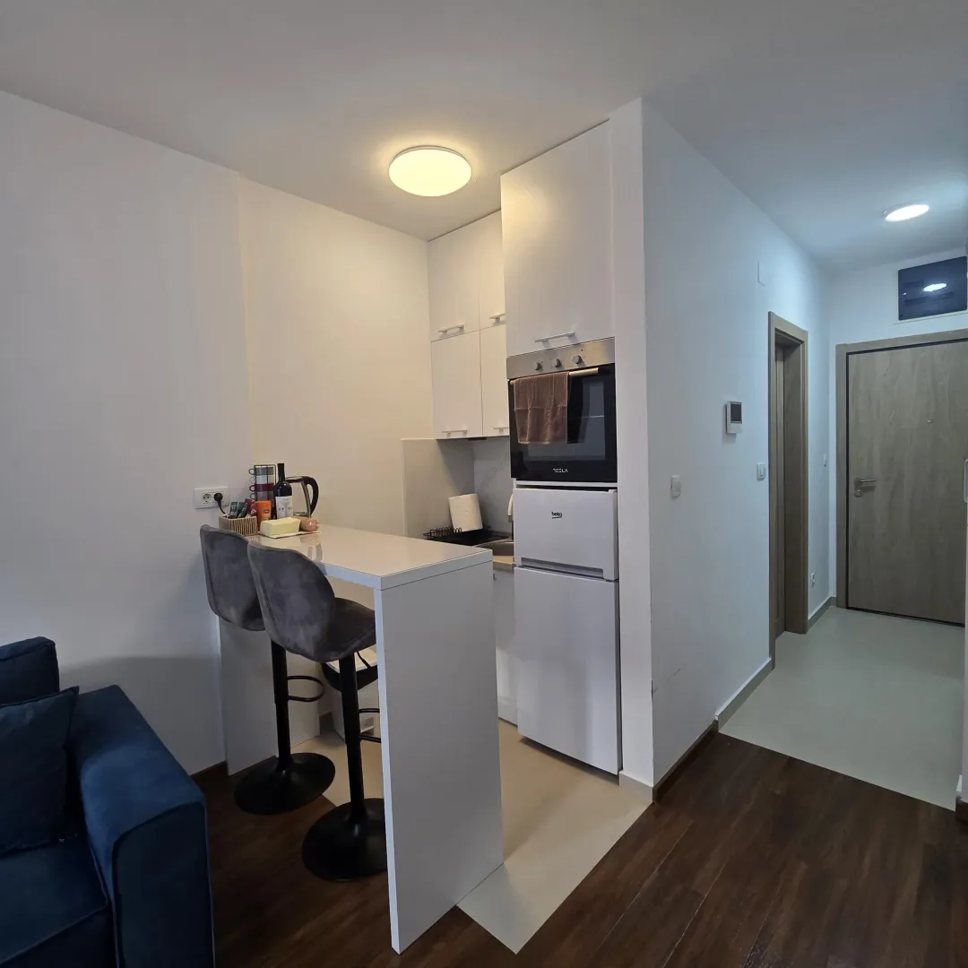 Small kitchen with a breakfast bar and built-in appliances.