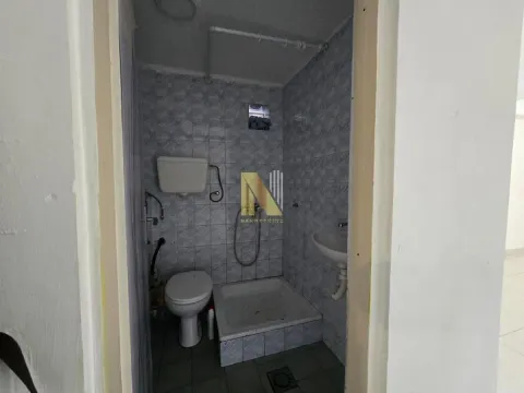 Smaller bathroom with a shower cabin, toilet, and sink. - image 14