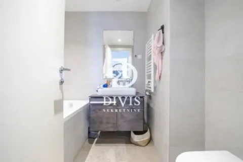 Modern bathroom equipped with a washbasin, mirror, and bathtub. - image 7
