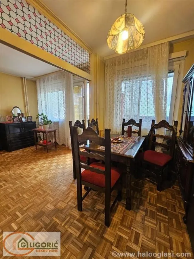 Living room with a dining table and rustic wooden furniture.